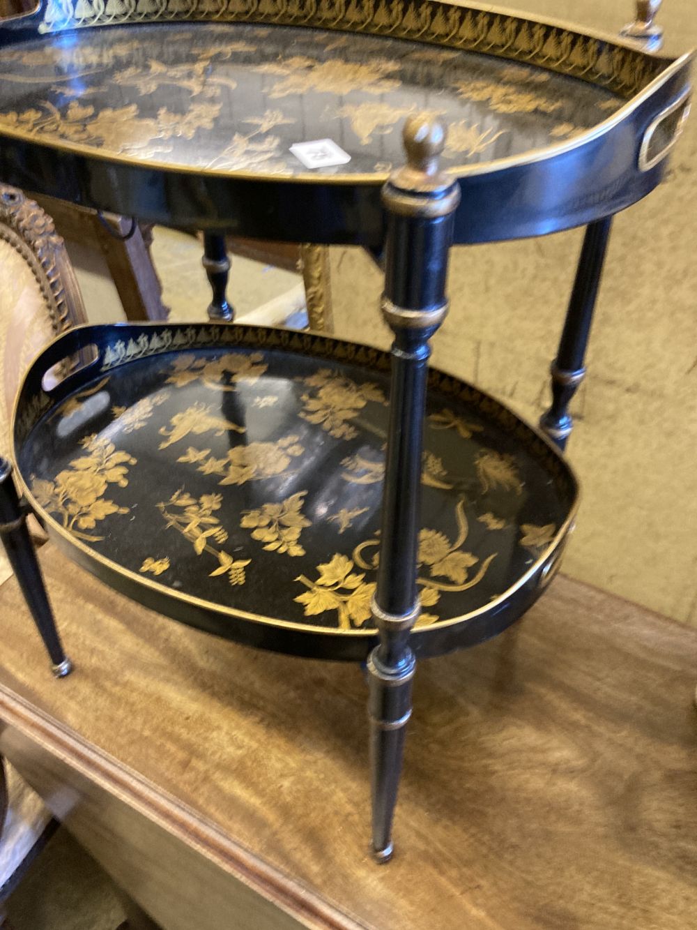 A black and gold japanned two tier toleware tray table, width 48cm, depth 36cm, height 57cm